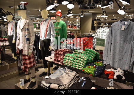 New York, NY, USA. 08th Dec, 2015. Eye-catching Christmas sweaters hang in a store at Herald Square in New York, NY, USA, 08 December 2015. Wearing not very tasteful Christmas sweaters has become a tradition in the USA. Even retailers now offer the flashy sweaters, which are quite popular at Christmas parties. Photo: Chris Melzer/dpa - NO WIRE SERVICE -/dpa/Alamy Live News Stock Photo