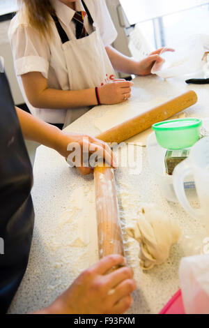Secondary education Wales UK: Pupils preparing to cook food in a food technology (domestic science) school teaching kitchen classroom Stock Photo