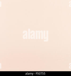 square background from peachy color toned sheet of paper Stock Photo