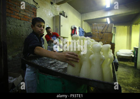 Cairo. 12th Dec, 2015. Egyptian workers make candy dolls for the upcoming celebration for the birth of Prophet Mohamed at a local factory in Cairo, Egypt, Dec.12, 2015. Muslims will celebrate Moulid El-Nabi, the birthday of Prophet Mohamed on 23 December this year, on which giving children a candy doll as a gift is a tradition. © Ahmed Gomaa/Xinhua/Alamy Live News Stock Photo