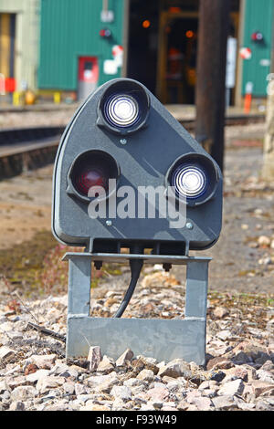 Ground Position Signal mounted close to the ground  within the depot showing two white 'clear to proceed' lights. Stock Photo