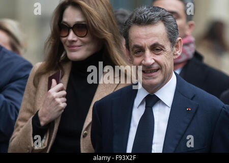 Paris, France. 13th Dec, 2015. Leader of the right wing party The Republicans and former French President Nicolas Sarkozy Nicolas Sarkozy (R) and his wife Carla Bruni-Sarkozy arrive to vote in the second round of French Regional Elections in Paris, France, Dec. 13, 2015. French far-right National Front party, who reported a historic victory during first round of the French regional election last week, failed on Sunday during the final round of the runoff. © Jean Bodard/Xinhua/Alamy Live News Stock Photo