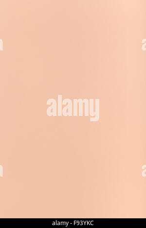 vertical background from peachy colored sheet of paper Stock Photo