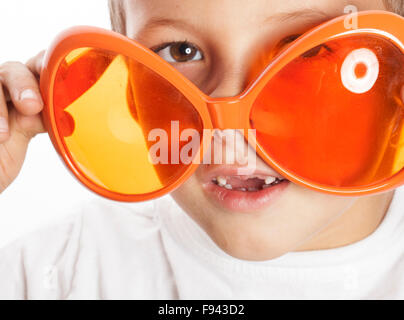 little cute boy in orange sunglasses pointing isolated close up part of face Stock Photo