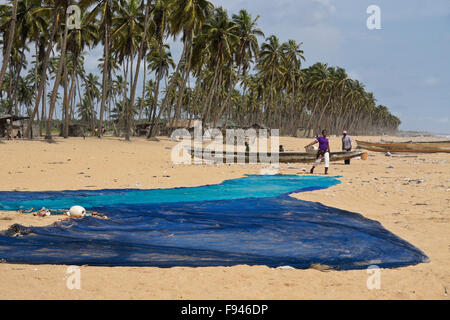 Fishing nets, boats, and shacks of Ghanaian fishermen, Ouidah beach, Benin Stock Photo