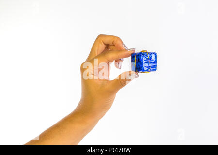 Woman's hand with silver nails holding a blue parcel Stock Photo