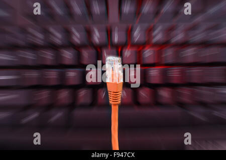 Internet cable in front of blurry keyboard with zoom Stock Photo