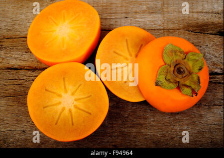 persimmon fruit on wooden background Stock Photo