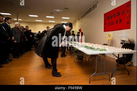 Toronto, Canada. 13th Dec, 2015. People attend a memorial for the Nanjing Massacre victims, in Toronto, Canada, Dec. 13, 2015. Japanese invading troops captured Nanjing, then China's capital, on Dec. 13, 1937 and killed 300,000 unarmed people in a massacre lasting for more than a month. © Zou Zheng/Xinhua/Alamy Live News Stock Photo