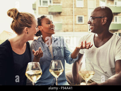 Friends out dining, multi ethnic concept, laughing and having a good time Stock Photo