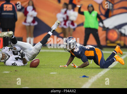 Denver, Colorado, USA. 13th Dec, 2015. Broncos WR EMMANUEL SANDERS, right, tries to gain control of the ball after fumbling the punt during the 2nd. Half at Sports Authority Field at Mile High Sunday afternoon. The Raiders beat the Broncos 15-12. Credit:  Hector Acevedo/ZUMA Wire/Alamy Live News Stock Photo