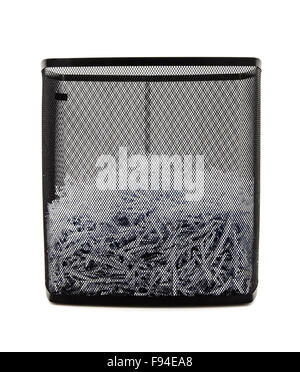 Paper shredder with metal wire basket filled with shredded documents on white background Stock Photo