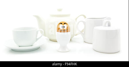 Breakfast egg with happy face tea pot and cup on white background Stock Photo