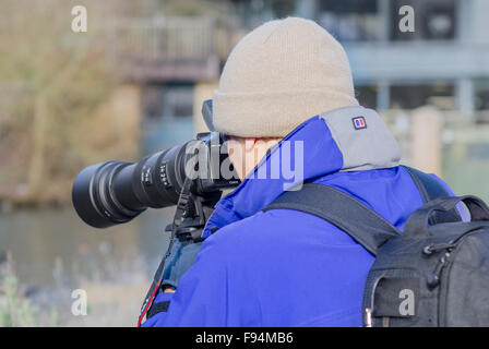 Male photographer with a long telephoto lens. Stock Photo