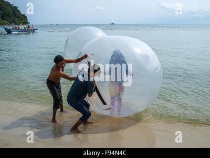 Muslim Tourist Inside A Water Walking Ball On Monkey Beach In Nan National Park, Penang Island, George Town, Malaysia Stock Photo