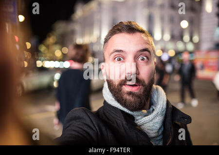 Young handsome man with coffee cup in London city Stock Photo