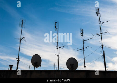 Group of analogic old antennas and digital dishes antennas on roof Stock Photo