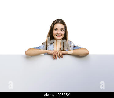 Successful business woman is standing and holding blank banner, isolated background. Stock Photo