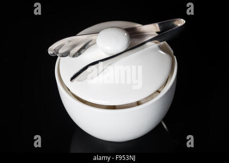 Sugar bowl and sugar tongs Stock Photo