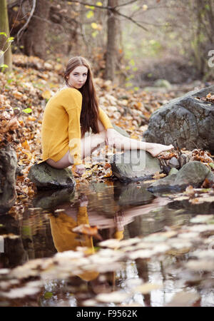 Outdoor portrait of beautiful girl in autumn forest Stock Photo