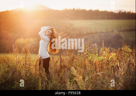 Outdoor portrait of beautiful woman in autumn meadow Stock Photo