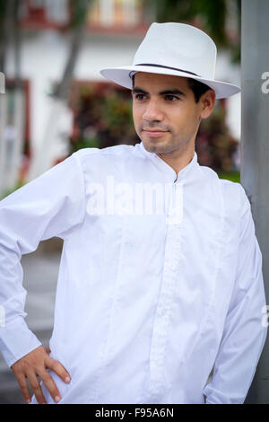 Hispanic man in white shirt and white hat Stock Photo