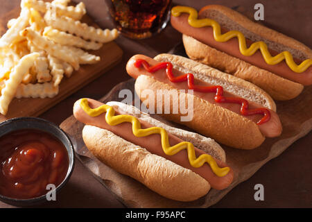 grilled hot dogs with mustard ketchup and french fries Stock Photo