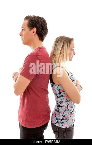 Young couple standing back to back isoalted on white bakground mad at each other Stock Photo