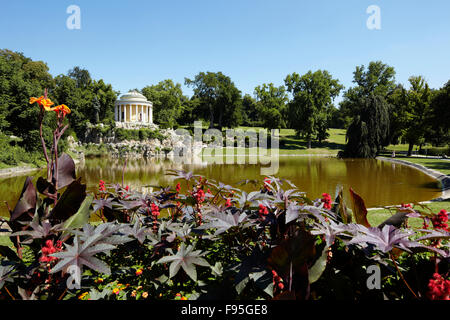 Leopoldinentempel, Schlosspark Esterhazy, Eisenstadt. View of the back garden of Leopoldinentempel with a close up of the flowers in front of the lake. Stock Photo