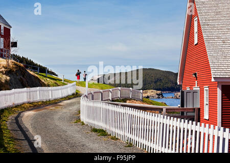 Picket fences on both sites of West Street in the town of Trinity, Newfoundland. On the right is the Rising Tide Theatre. Stock Photo