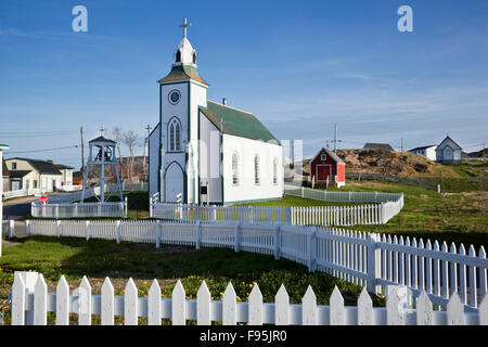 Holy Trinity Roman Catholic Church surrounded on all sides by white picket fences. Trinity, Newfoundland Stock Photo