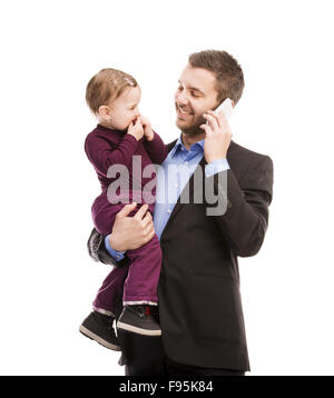 Man with his baby is working. Manager is using mobile phone. Stock Photo