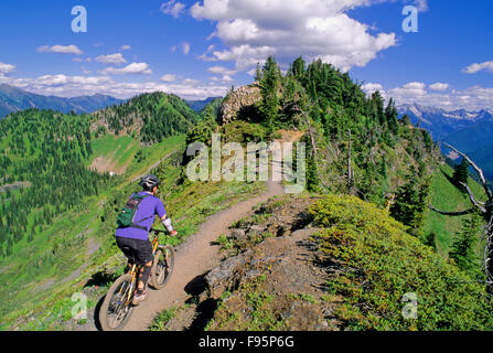 A man rides the ridge trail on Idaho Peak in the Kootenays near Silverton, B.C Stock Photo