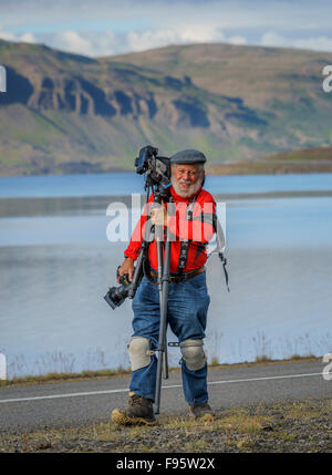 Photographer with tripod, in Hvalfjordur, Iceland Stock Photo