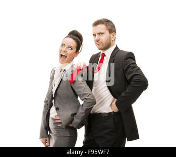 Young smiling business woman and business man isolated over white background. Crazy and funny posing in studio. Stock Photo