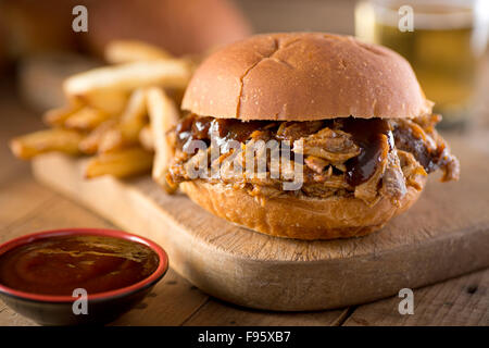 A delicious pulled pork sandwich with barbecue sauce on a bun. Stock Photo