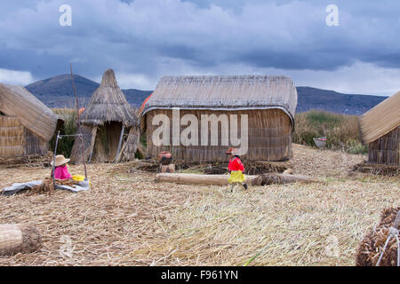 Local residents of floating reed islands of Uros, Lake Titicaca, Peru Stock Photo