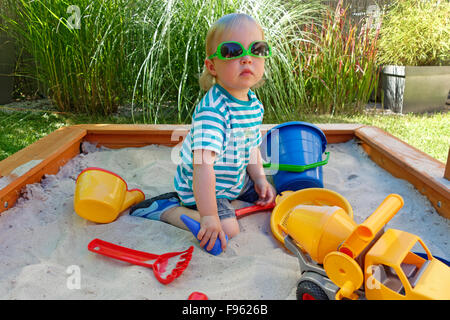 Toddler, girl playing in sandbox, Germany Stock Photo