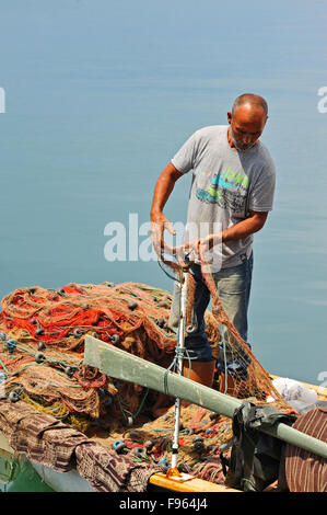 fisherman sorting his net, Ayvalik, Turkey Stock Photo