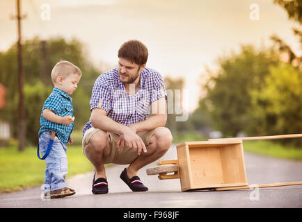 Young father talking with his little son on street Stock Photo