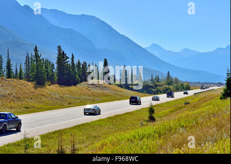 A view of vehicles traveling on Alberta's highway 16 as it wanders through Jasper National Park Alberta Canada Stock Photo