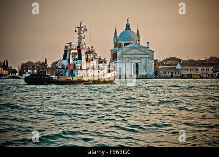 tugboat passing Il Redentore church Stock Photo