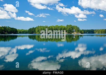 Clouds reflected in Clear Lake, near Parry Sound, Ontario, Canada Stock Photo