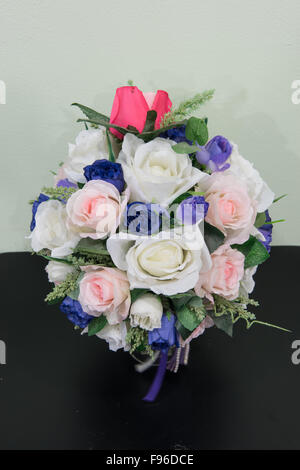 Artificial flowers bouquet in vase on the table Stock Photo