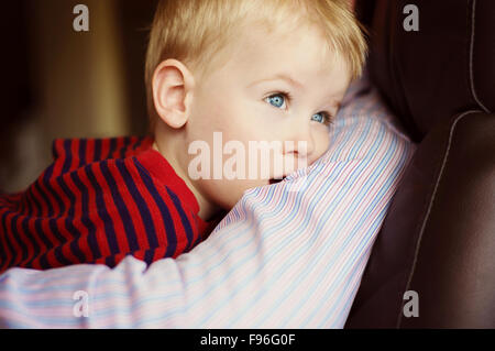 Little boy relaxing at home with his father Stock Photo