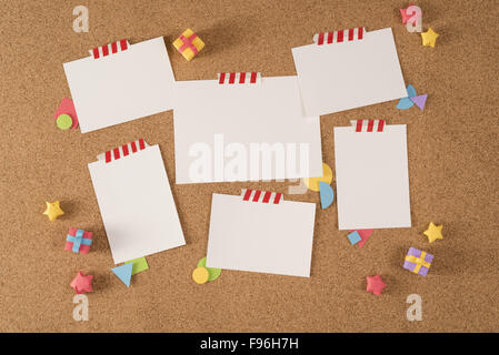 Set of blank paper template notes taped on cork notice board with colorful handmade elements. Includes clipping path mock up for Stock Photo