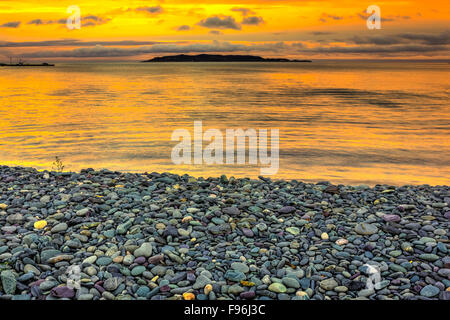 View of Gull Island at sunrise from Witless Bay Beach, Witless Bay Ecological Reserve, Newfoundland, Canada Stock Photo