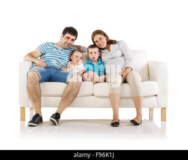 Portrait of the happy family with two children and pregnant mother sitting on sofa, isolated on white background Stock Photo