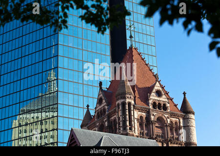 In the foreground is the central tower of Boston's Trinity Church, a National Historic Landmark located in Copley Square at the Stock Photo