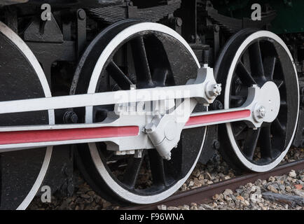 Old steam locomotive drive wheels on railway track. Stock Photo